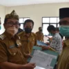 TUNJUK BUKTI. Bupati Cirebon, H Imron menunjukkan e-KTP hasil pencetakan di Kecamatan Losari, kemarin.